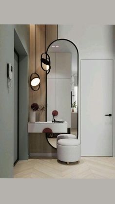 a white chair sitting in front of a mirror on top of a wooden floor next to a sink