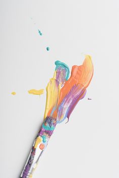 an artistically painted toothbrush on a white surface