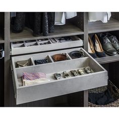 an open drawer in a closet filled with shoes