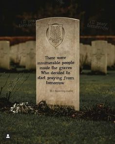 a grave with a quote on it sitting in the grass next to some headstones