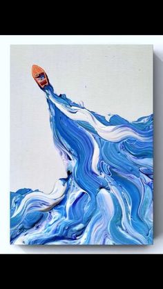 an abstract painting with blue and white swirls on the bottom, orange shoe above it