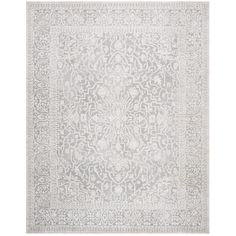 a gray and white rug with an intricate design on the bottom, in front of a white background