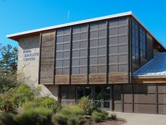 a large building with a metal roof on the top of it's front entrance