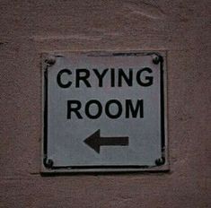 a sign on the side of a building that says crying room and an arrow pointing to the right