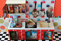 a toy kitchen with lots of cooking utensils