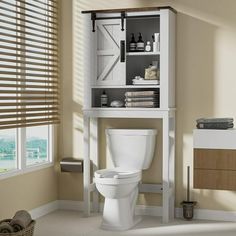 a white toilet sitting in a bathroom next to a cabinet with shelves on the side