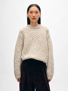 Nothing evokes snow days by the fire quite like this crewneck sweater. Featuring a Nordic-inspired Fair Isle motif, it’s made of a responsibly sourced alpaca wool blend from Peru for an extra cozy hand feel. The relaxed fit and low-hip hem pairs perfectly with high-rise jeans. Details Relaxed fit. Long sleeve. Length in size small is 24 1/2". The model is 5'8 1/2" and is wearing a size small. 70% Baby Alpaca, 23% Recycled Polyamide, & 7% Wool. Dry clean only. Style #21187 Oat Straw, Jeans Details, Cashmere Travel Wrap, Snow Days, Cardigan Top, Wrap Sweater, Sweater Sale, Baby Alpaca, Knitwear Cardigan