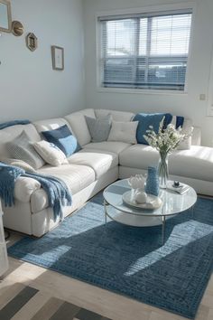 a living room filled with furniture and a blue rug