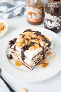 a piece of tirami cake on a white plate with nuts and peanut butter