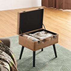 an open suitcase sitting on top of a wooden table