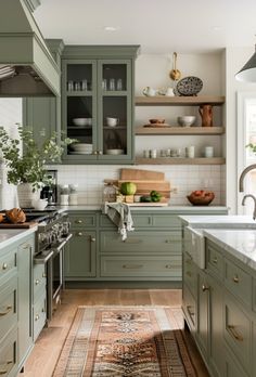 a kitchen filled with lots of green cabinets and counter top space next to a rug