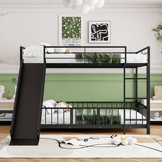 a bunk bed with a slide next to it in a room that has green walls