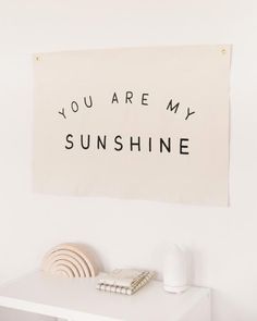 a white table with a sign that says, you are my sunshinene on it