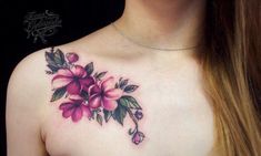 a woman's chest with pink flowers on it