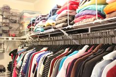 a rack filled with lots of clothes next to a closet full of shirts and pants