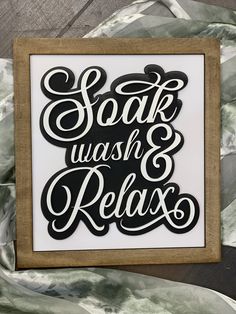 a framed sign that says, soak wash and relax