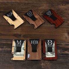 four different types of money clip holders on top of a wooden table