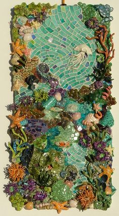 an art piece made out of various types of seaweed and other marine life on a white background