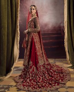 a woman in a red and gold bridal gown