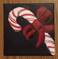 a painting of candy canes on a black background