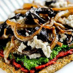 a sandwich with mushrooms, cheese and other toppings