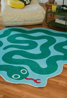 a living room area with a rug on the floor and a couch in the background