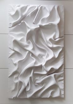 an abstract painting with white paint on the wall