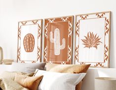 three framed cactus art prints on the wall above a bed with pillows and throw pillows