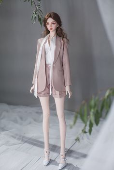 a doll is dressed in a suit and shoes