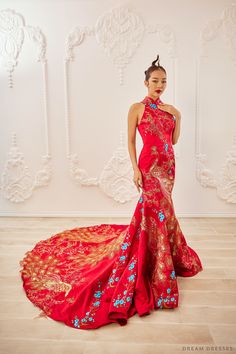 Elevate your wedding day in our Ruyi Red Bridal Cheongsam, a modern marvel inspired by traditional Chinese design. This captivating mermaid silhouette gown features a Mandarin collar, exuding elegance and tradition. The keyhole back adds a touch of allure, while the thoughtful addition of bra cups ensures comfort throughout your special day. Embrace the symbolism of the phoenix with its exquisite embellishments, as you celebrate your love story in style and grace. The dress: Chinese inspired wed Fitted Red Mermaid Dress For Weddings, Red Mermaid Dress For Wedding, Red Wedding Gown With Long Train, Red Fishtail Mermaid Dress For Wedding, Red Fishtail Dress For Wedding, Red Fishtail Wedding Dress, Red Fitted Wedding Dress For Ceremony, Bridal Cheongsam, Chinese Inspired Wedding