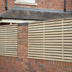 a brick wall with wooden slats on it