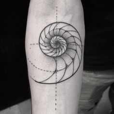 a black and white photo of a spiral tattoo