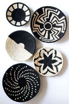 three black and white baskets sitting next to each other on top of a table together