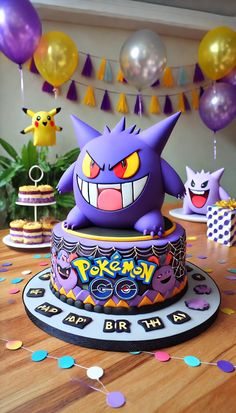 a pokemon birthday cake with balloons and streamers