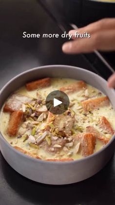 someone is cooking food in a pot on the stove top and touching it with their finger