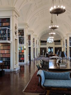 a large library with many bookshelves filled with lots of bookcases and furniture