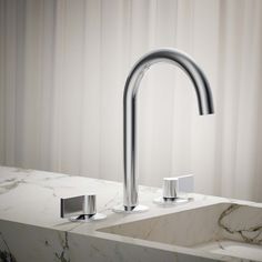 a bathroom sink with two faucets on the side and a marble counter top