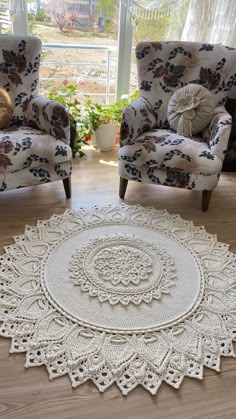 two chairs and a rug in front of a window