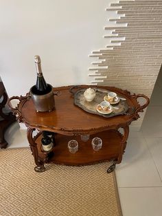 a table with two wine glasses on it and a bottle of wine in the middle