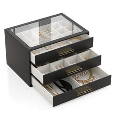 three drawers with jewelry in them on a white background