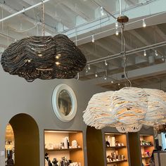 several chandeliers hanging from the ceiling in a room with bookshelves and shelves