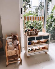 a baby's room with a toy crib and toys in it