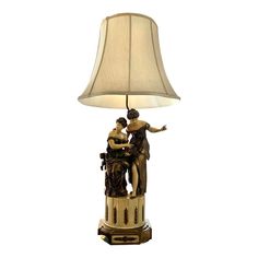 a lamp that is sitting on top of a table next to a lamp shade with an image of two women hugging each other