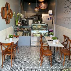 the inside of a restaurant with tables and chairs