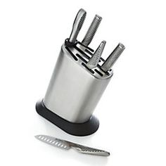 a knife holder with four knives and a toothbrush in it on a white background