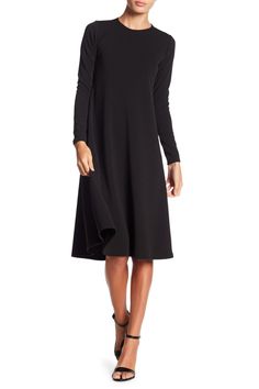 This long sleeve A-line dress is great for the office or dinner and makes for a classy, put-together look. Fit: this style runs small. 43" length (size Small) Crewneck
 Long sleeves A-line skirt 47% polyester, 47% rayon, 6% spandex Machine wash Made in the USA Model stats: 5'10", 32" bust, 25" waist, 36" hip. Model is wearing size Small. Sleek Solid Dresses For Fall, Sleek Solid Color Fall Dresses, Solid A-line Long Sleeve Dress For Fall, Black A-line Long Sleeve Dress For Winter, Chic Long Sleeve A-line Dress For Fall, Chic A-line Long Sleeve Dress For Fall, Black A-line Long Sleeve Formal Dress, Solid Color A-line Long Sleeve Dress For Fall, Solid Long Sleeve Midi Dress For Office