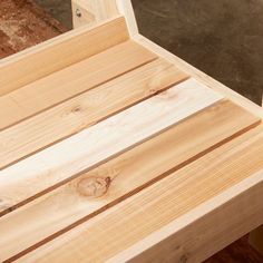 a wooden bench sitting on top of a hard wood floor