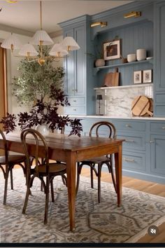 a dining room table and chairs with blue cabinets