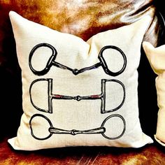 a pillow with scissors drawn on it sitting on a couch