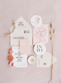 the wedding stationery is laid out on top of each other